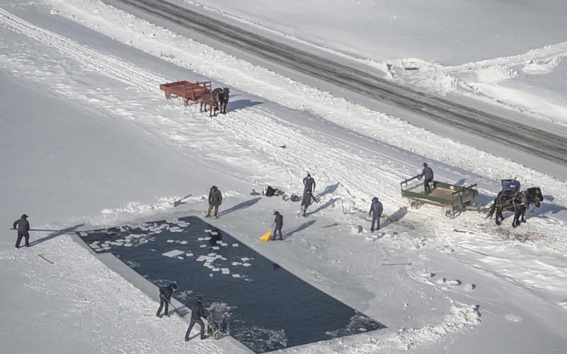 An aerial view of Amish cutting and collecting squares of ice and putting them on to horse drawn carts. PHOTOS PROVIDED BY ROGER HAINES
