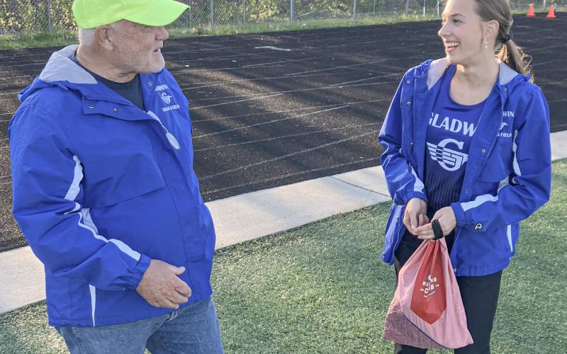 Longtime Gladwin girls’ track coach Kernie Gilliam shares a laugh with junior Bree Visser at the Northern Michigan Meet of Champions.