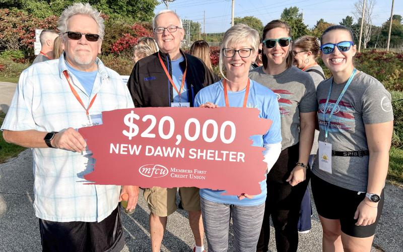 New Dawn Shelter is pictured receiving a donation from Members First Credit Union.