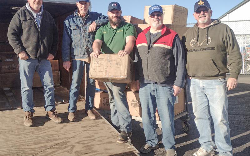 The Gladwin Christian Men’s Club Picking up 2024 boot order at Family Farm &amp;amp; Home. Inset photo, boots delivered to Beaverton.