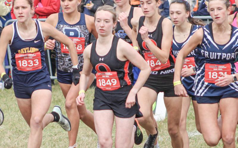 Gladwin’s Alanis Povey takes off with the crowd after the starting gun went off at the Division 2 State Meet Saturday at Michigan International Speedway.