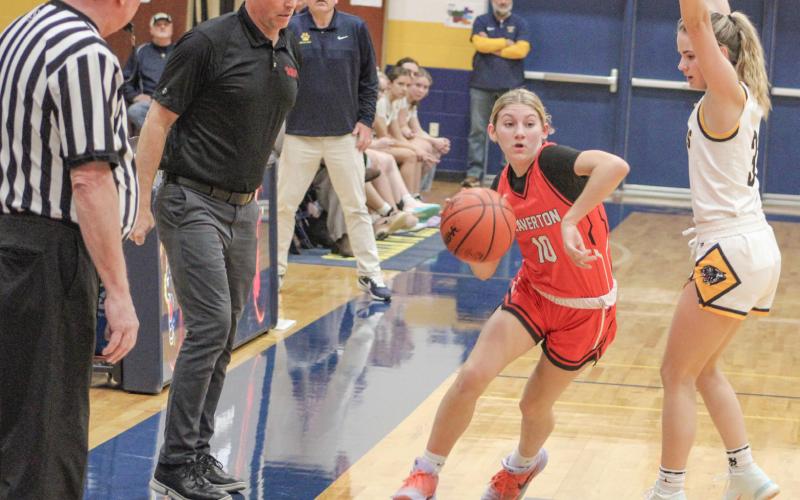 Beaverton’s Rylan Tabaszewski toes the line in front of Coach Jason Hubble during last weekend’s victory at Standish for the Jack Pine Conference championship.