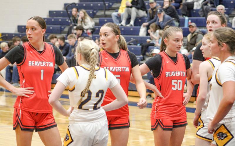 The wall has formed and Beaverton’s (left to right) Trinity Danielak, Harper Pollard, Myah Hubble and Taryn Roberts are checking the bench for the play call.