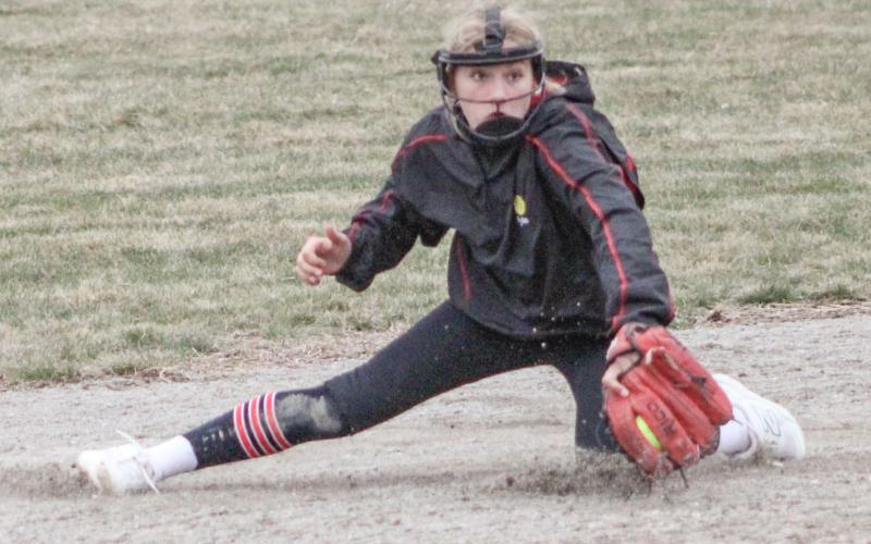 Beaverton shortstop Rylan Tabaszewski digs up a ground ball before throwing a runner out at third base during Friday’s doubleheader with Oscoda.