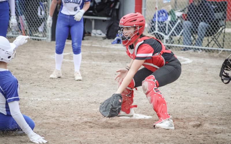 Beaverton catcher Harper Pollard waits for the ball to arrive as an Oscoda base runner slides into home during Friday’s doubleheader split.
