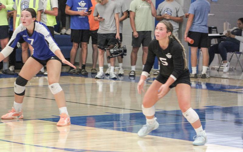 Gladwin’s Ansley Mausolf and Addison Tyslicki get into position on serve receive during last Wednesday’s victory over Standish.