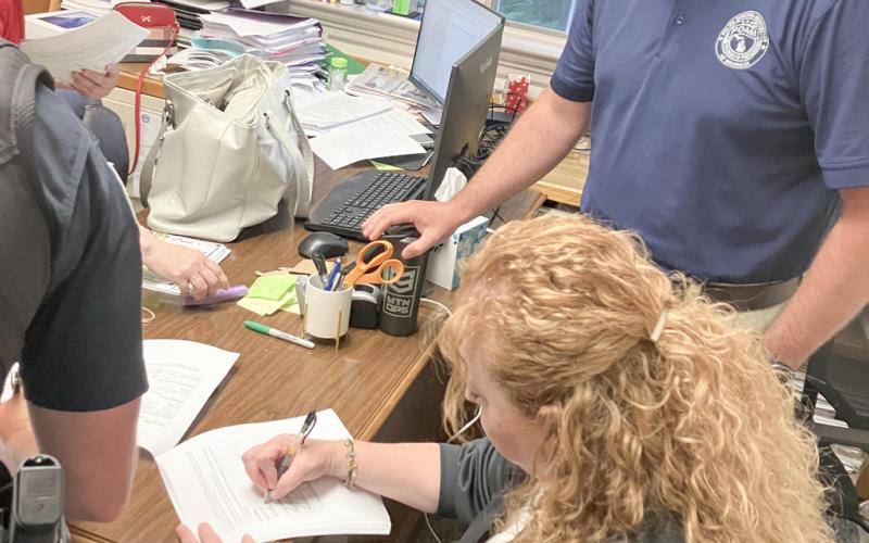 Gladwin Mayor Sarah Kile signs a new contract between the city and its police officers, represented by POAM Business Agent Adam Walser, after Monday’s City Council meeting.