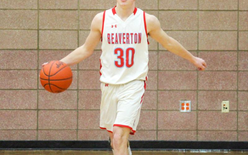 Junior Layk Woodruff, slow and confidently, dribbles the ball down the court