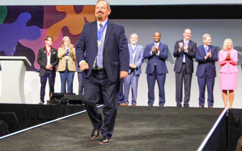 Pictured walking downstage is Mid Michigan College President, Tim Hood, who was named as a recipient of the Paragon Award for New Presidents.