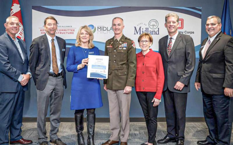 Gathered after the signing of the agreement for the General Investigation study with the Corps of Engineers are pictured, left to right: Mark Bone, chair, Midland County Board of Commissioners; J.W. Fisher and Lee Ann Keller, co-chairs of the Midland Business Alliance (MBA) Advisory Committee on Infrastructure; Lt. Col. Wallace Bandeff, commander, U.S. Army Corps of Engineers Detroit District; Maureen Donker, mayor, City of Midland; Brad Kaye, Midland city manager; and Tony Stamas, president and CEO, MBA.