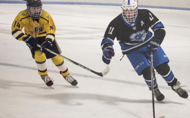 Clay Newman stickhandles across the blue line Saturday as the Gladwin hockey team beat the MId-Michigan Raptors for three wins in a row.