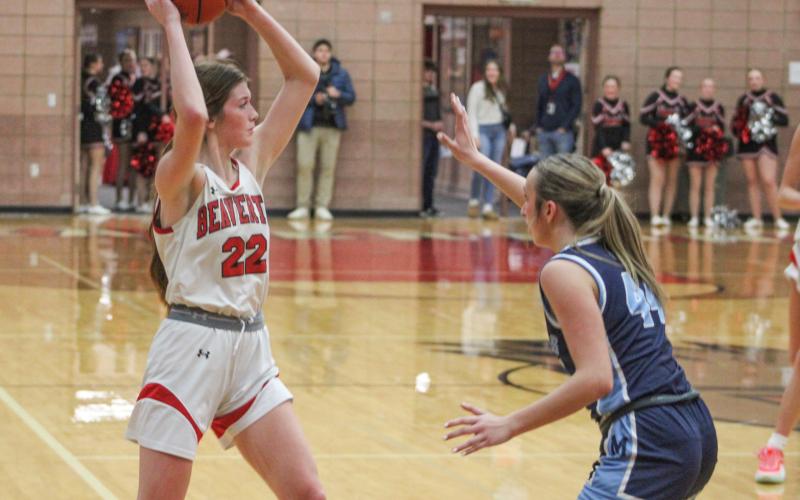 Beaverton’s Bryar Pollard holds the ball high and looks for an open teammate during Friday night’s loss to Jack Pine Conference leader Meridian. The Beavers will visit rival Gladwin Friday.