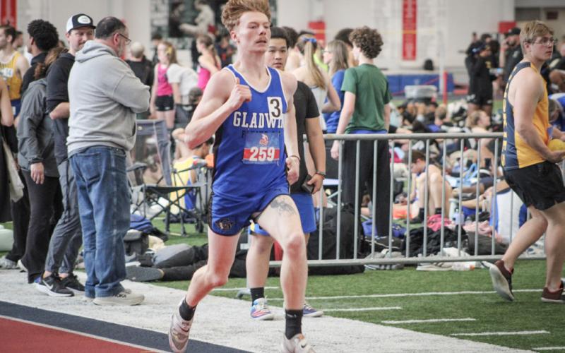 Gladwin’s Drake Ross competes in the 400 after placing fourth in the pole vault last Wednesday at Saginaw Valley State University.