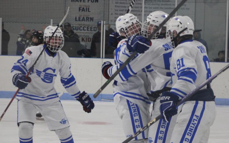 Hunter Simpson celebrates with his teammates after scoring a goal in the third period Friday night in a win over Cheboygan.