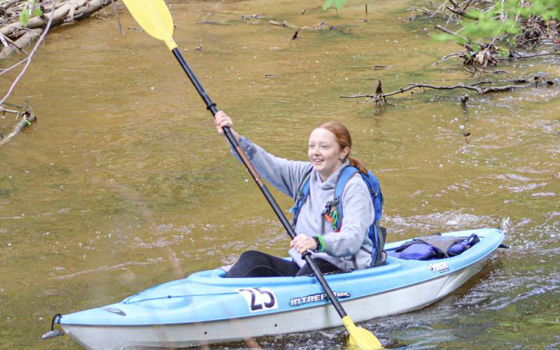Olivia Klein paddles her No. 25 kayak past the check point at Buckeye Trailhead with a smile as she realizes she had passed the midway point of the Race of Two Cities.