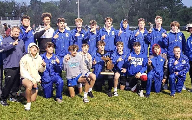 The Gladwin Boys Track and Field team with their freshly won 2023 MHSAA Regional Trophy.