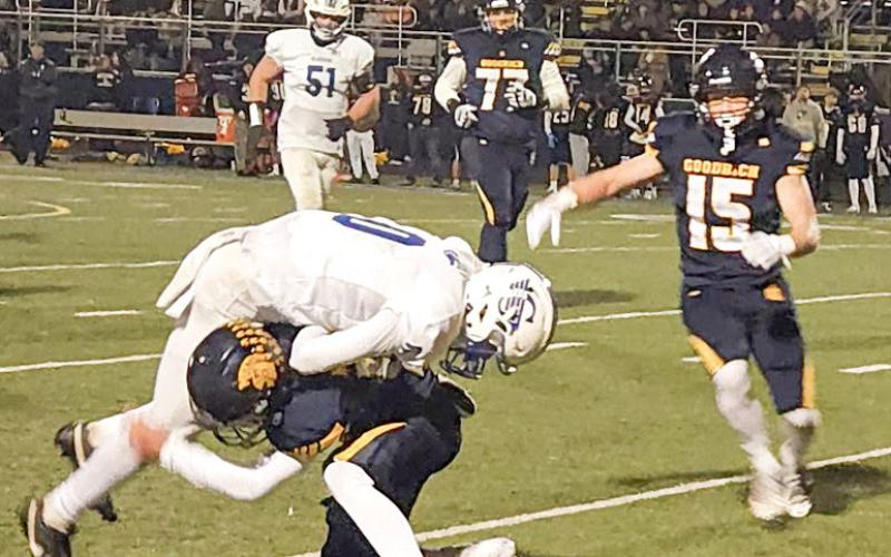 Gladwin receiver Bronson Bigham is denied more yards after the catch during Friday night’s regular-season finale at Goodrich.