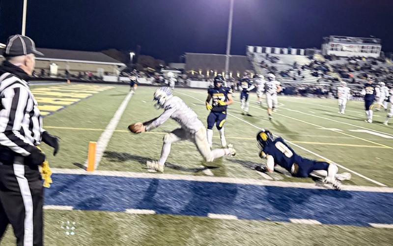 Gladwin’s Colton Pfenninger reaches across the goal line for a touchdown during Friday night’s loss at Goodrich.