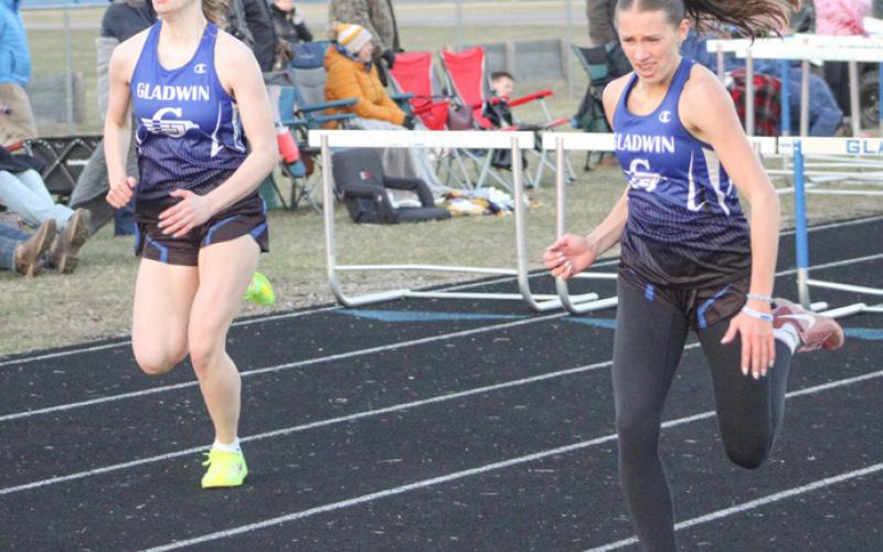 Gladwin hurdlers Charlotte Mawhorter (left) and Bree Visser sprint to the finish line during a recent meet.