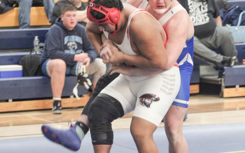 Gladwin’s Nick Brasseur tries to get a leg up on the competition in the district championship match Saturday at Shepherd. Brasseur placed second in a rugged weight class to qualify for the regional.