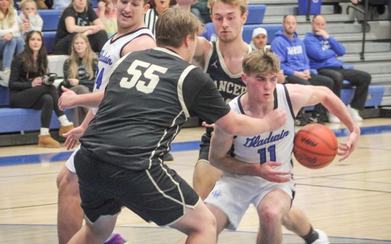 Gladwin’s Trace Corlew runs into a wall in the lane during Friday night’s victory over visiting Bullock Creek.