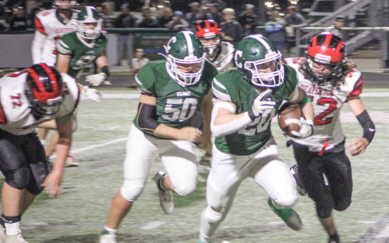 Beaverton’s Angel Cerda closes in on Clare ballcarrier Mason Heintz during the Pioneers 54-0 victory Friday night in a Jack Pine conference crossover. The win locked up a playoff berth for Clare with a 6-4 record.