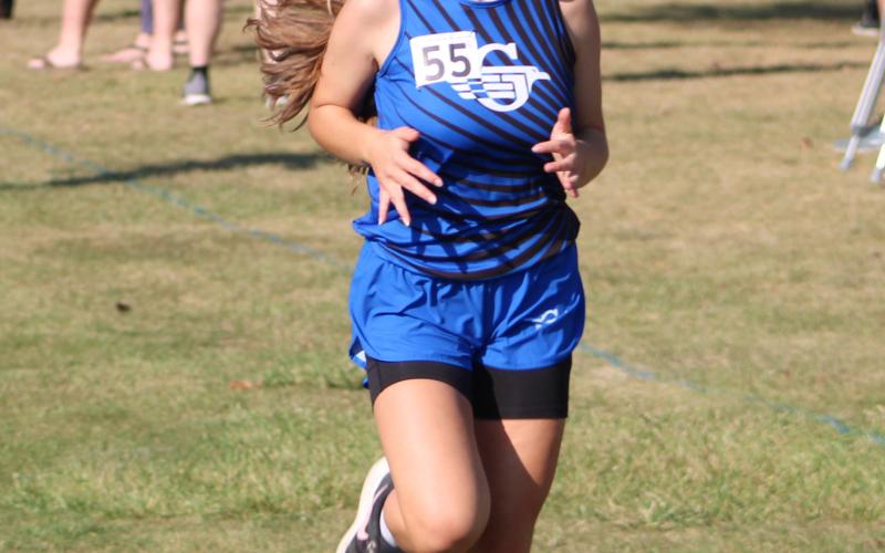 Gladwin’s Michaela O’Callaghan races to the finish line during a recent meet. The Flying G’s will run at the Northern Michigan Meet of Champions Saturday.