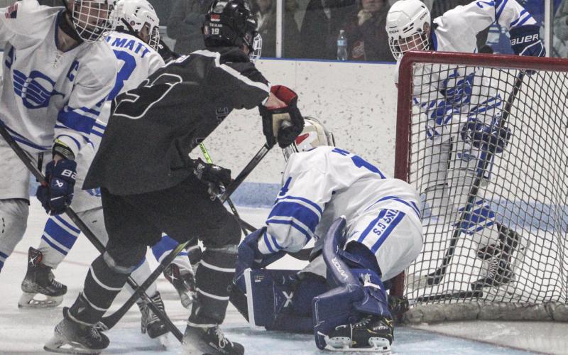 Gladwin goalie Preston Willert fights off the traffic in front of the net to make another save during Saturday night’s season-opening loss to visiting Jackson United.