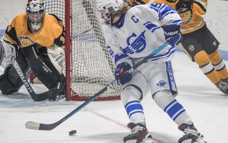 Gladwin’s Treyton Siegert goes to the backhand to cut in on the Madison Heights Bishop Foley goalie during Saturday’s victory over the visiting Ventures.