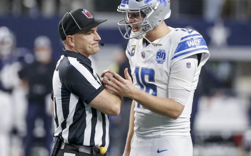 Detroit Lions quarterback Jared Goff (16) talks with umpire Duane Heydt after a 2-point conversion play by the Lions against the Dallas Cowboys in the second half of an NFL football game, Saturday, Dec. 30, 2023, in Arlington, Texas. The Cowboys won 20-19. AP PHOTO/MICHAEL AINSWORTH