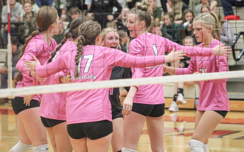 The Beaverton volleyball team celebrates after winning a critical point.
