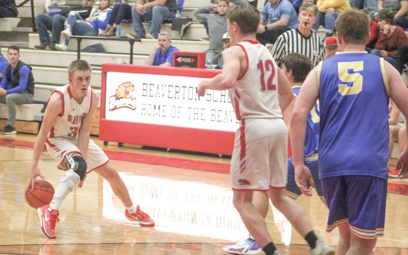 Beaverton’s Layk Woodruff goes between the legs with the dribble as he looks for an open teammate during the Beavers victory over Coleman Friday night.