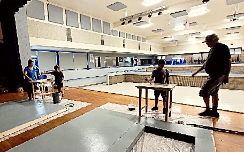 GAFT president Lorraine Carman with daughter, Katherine and son, William, working with set designer/builder, Ken Tate.