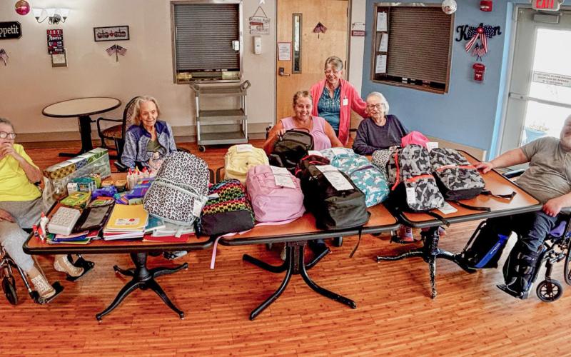 Residents at Gladwin Nursing and Rehabilitation Community show school supplies collected during their Back-to-School Drive.