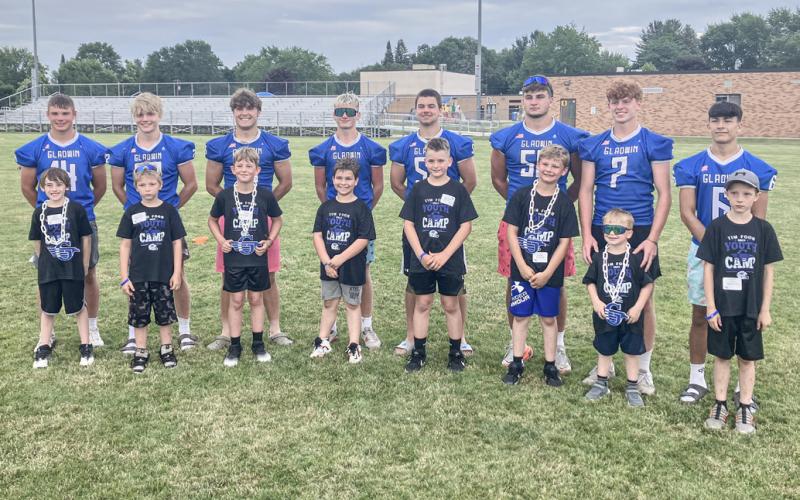 Gladwin varsity players and the award winners from their groups posed for a photo at the end of the Tim Foor Youth Football Character FUNdamentals Camp last week.