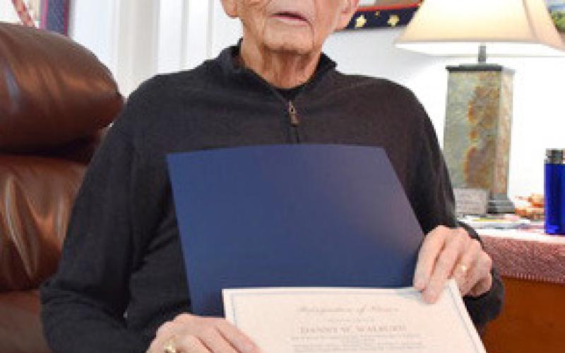 Danny Walburn pins lieutenant colonel insignia on his niece, Ashley Sykes. Below, Walburn holds his Vietnam Veteran Recognition Certificate. Inset photo, Danny Walburn.