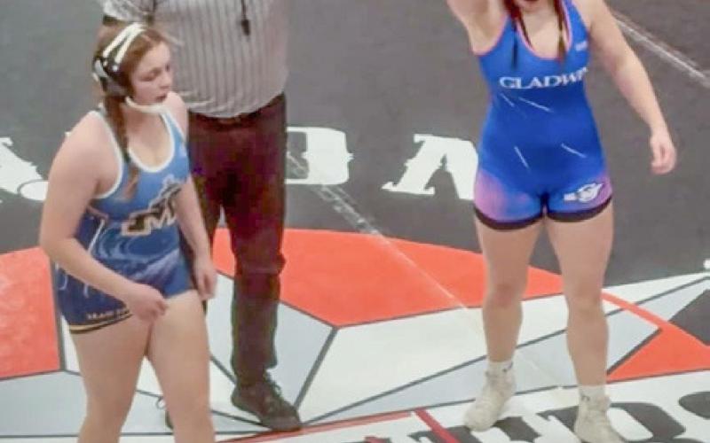 Gladwin’s Brielle McKinnon has her arm raised in victory after a match Friday at Manton.