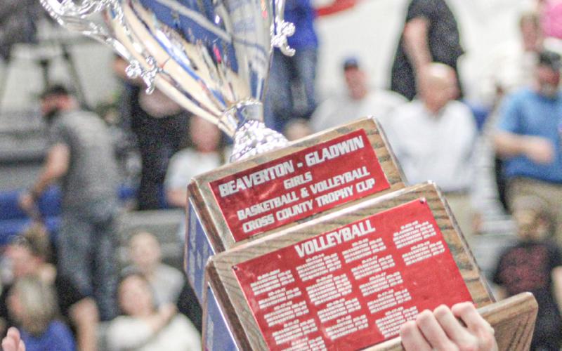 The Cedar Cup is hoisted toward the rafters last Wednesday night after the Gladwin volleyball team beat Beaverton.