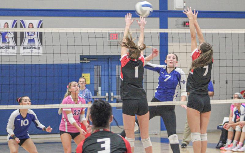 Gladwin’s Ansley Mausolf tries to blast one past Beaverton blockers Braylin Orton and Reese Mishler during a wild five-set Battle for the Cedar Cup last Wednesday.
