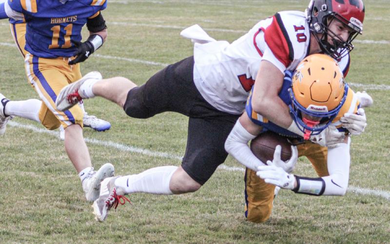 Beaverton’s Ian Roberts puts a stop to the forward progress of a Harrison ball-carrier Friday night. The Beavers fell to 2-2 on the season with a 36-20 loss.