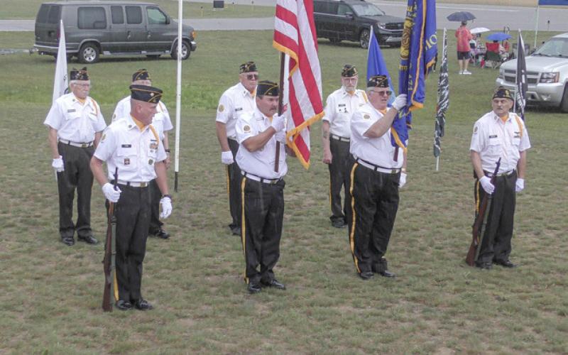 A remote controlled jet flies throught the sky over Zettel Memorial Airport. Inset photo, Gladwin American Legion Post 171 saluted the U.S. Armed Forces.