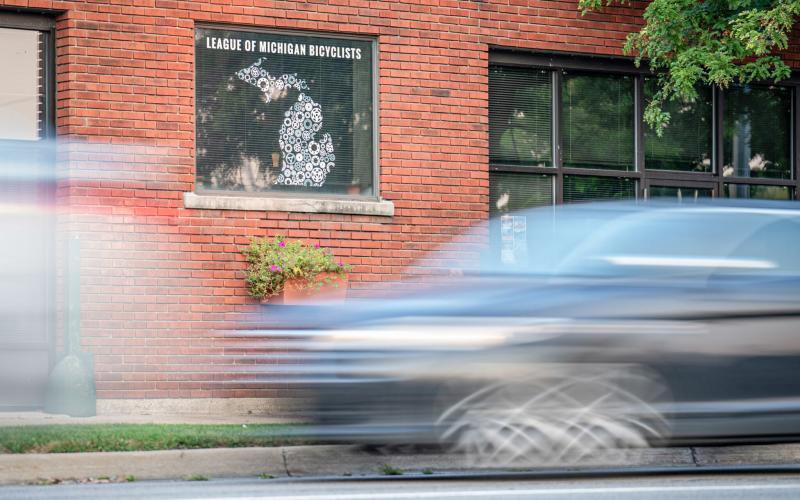 Cars pass in front of the League of Michigan Bicyclists office in Lansing. DONTÉ SMITH