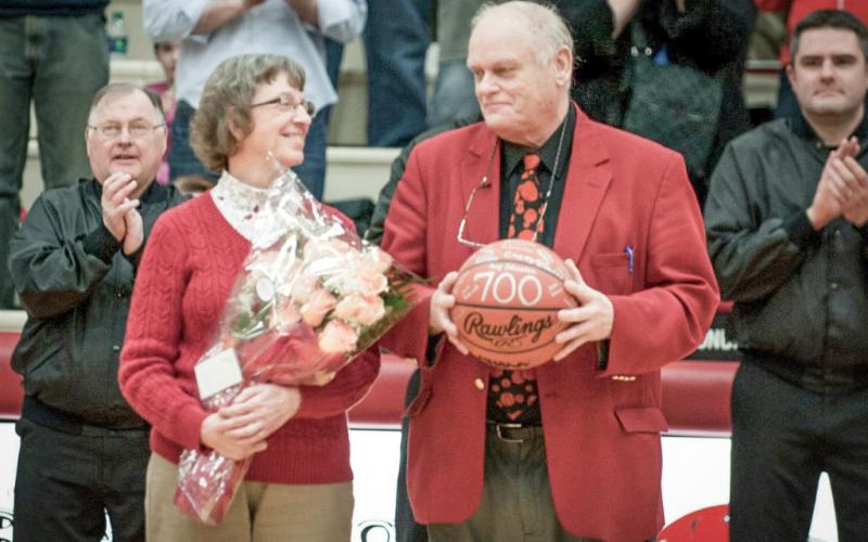 Beaverton basketball coach Roy Johnston and his wife Judy share a moment during a ceremony honoring Johnston for achieving his 700th career victory. He added 133 more before retiring at the end of this season.