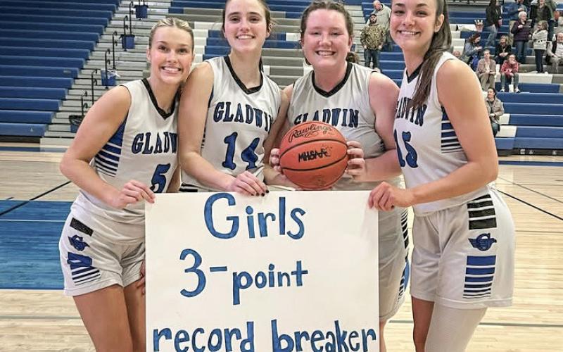 Gladwin seniors (left to right) Breanna Campbell, Abby Robinson, Sofia Sorensen and Ava Gary gather on Senior Night to celebrate Robinson’s new school record for 3-pointers in a season.