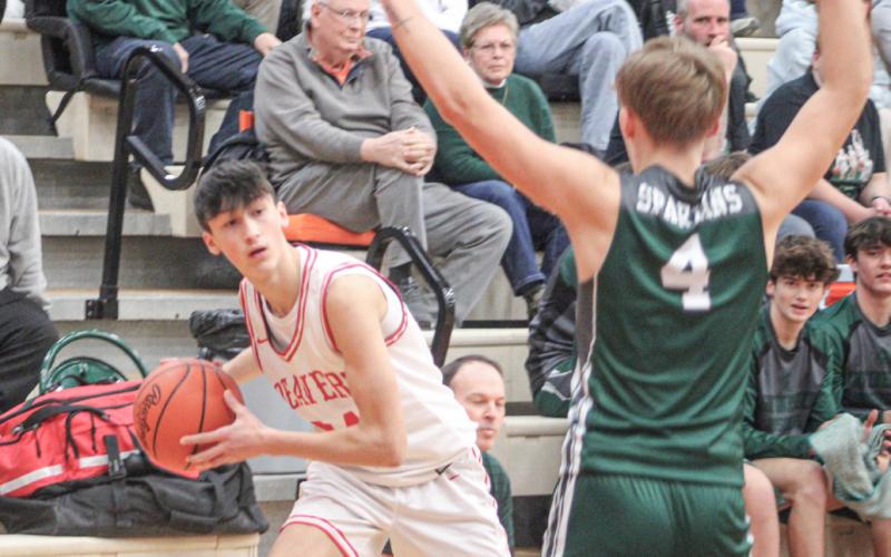 Beaverton’s Jace Mishler peers inside from the corner during Friday night’s overtime victory over Pinconning.
