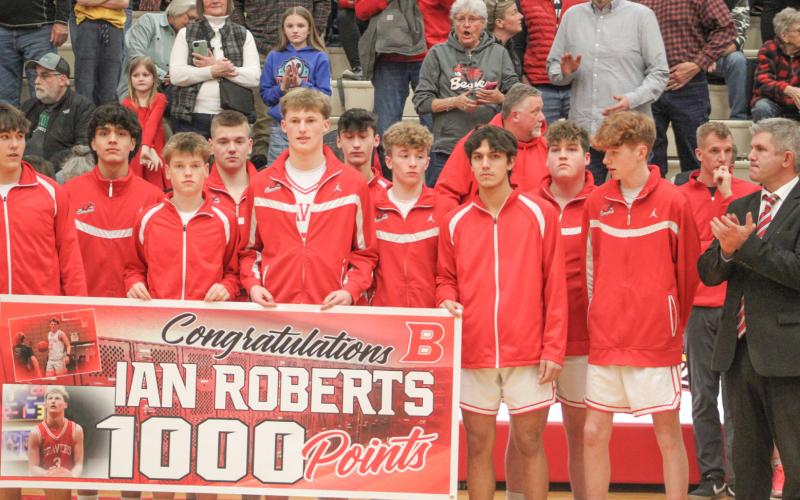 Ian Roberts and his teammates took a moment to celebrate the Beaverton junior scoring his 1,000th career point prior to Friday night’s game.