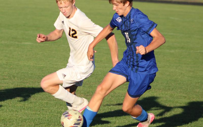 Gladwin’s Keaton Mausolf battles an Ithaca defender for the ball during Thursday’s hard-fought 2-1 loss.