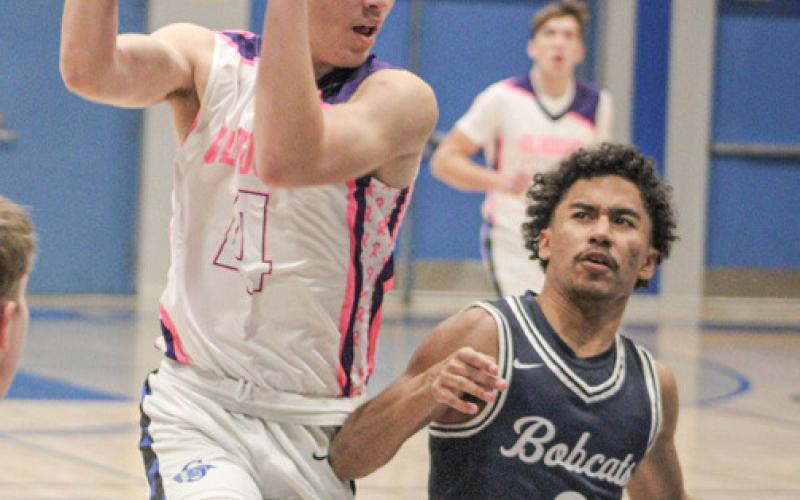 Gladwin’s Ben Verellen crashes into the paint during last week’s victory over visiting Bay City John Glenn on Coaches Vs. Cancer Night.