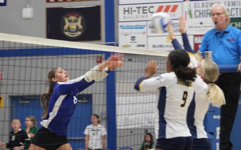 Gladwin’s Maddy Pagel tries to shoot one through the block during a match earlier this season.
