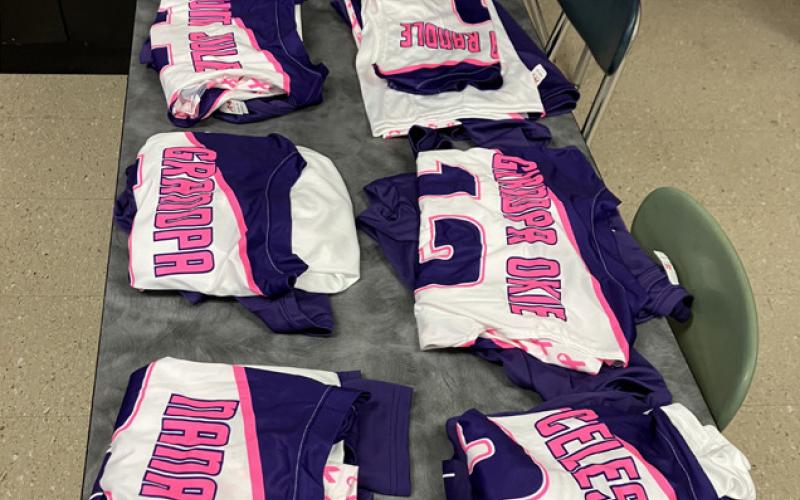 The special new jerseys for this week’s games are laid out for the players to pick up on a desk in a classroom at Gladwin High.